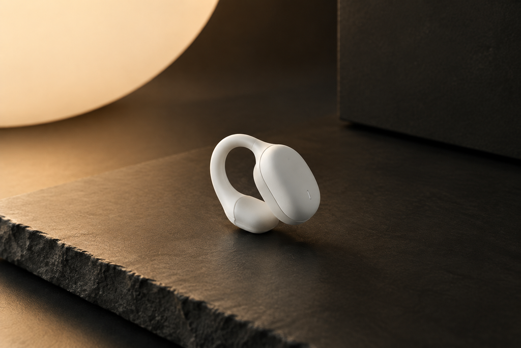 Premium white ear clip sleep aid device on dark slate surface, Bauhaus editorial style