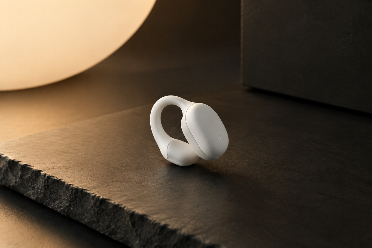 Premium white ear clip sleep aid device on dark slate surface, Bauhaus editorial style